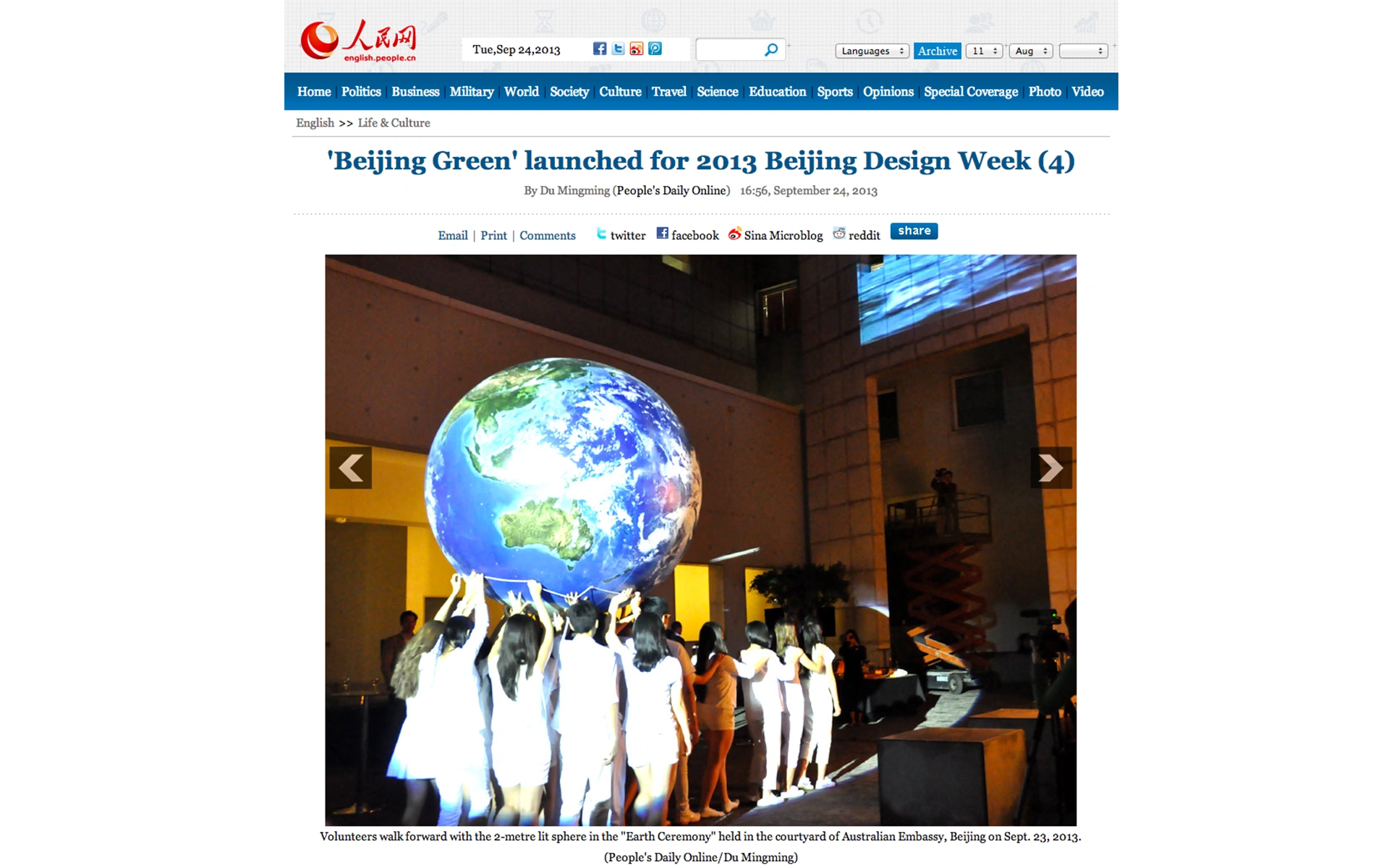 People’s Daily Online photo of volunteers carrying lit Earth sphere at Australian Embassy