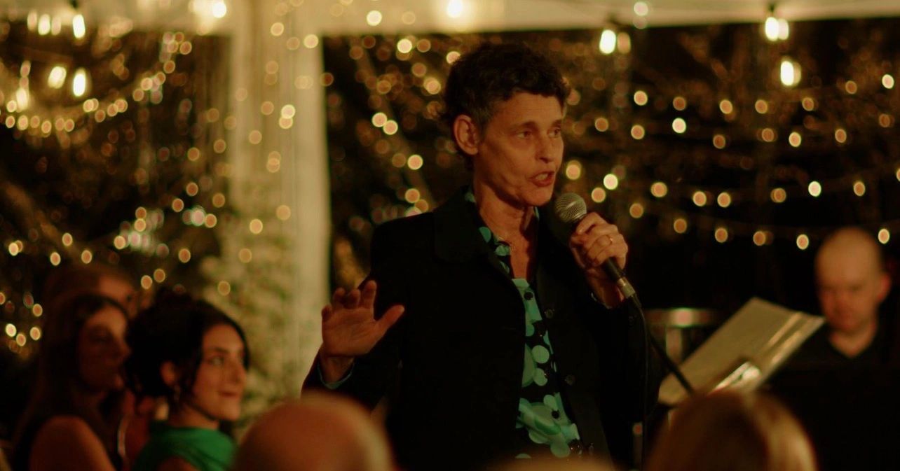 Speaker at Sunset Garden Talks under warm evening lights